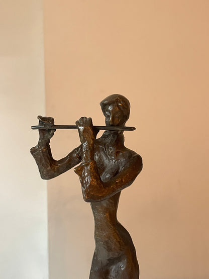Sculpted Bronze Flutist in Windswept Dress on Black Podium